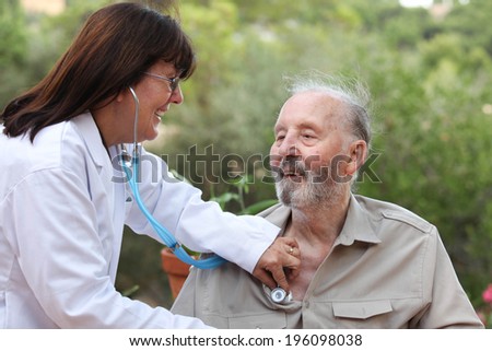 dr with stethoscope checking senior patients heat beat