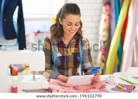Seamstress with credit card using tablet pc
