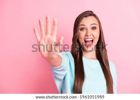 Photo of pretty funky young woman raise hand give high five you excited isolated on pastel pink color background