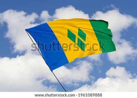 Saint Vincent flag isolated on sky background with clipping path. close up waving flag of Saint Vincent. flag symbols of Saint Vincent.