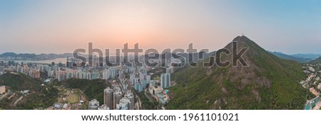 Amazing panorama aerial view near Kowloon Peak, downtown residential district, evening golden hours