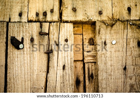 wooden wall with rusty nails