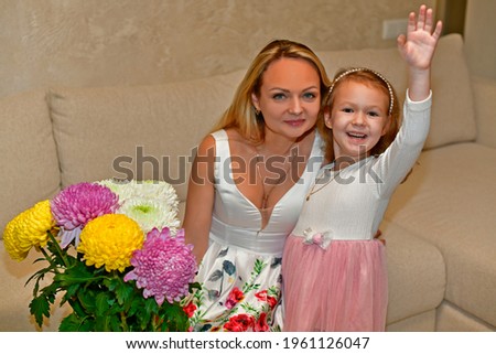 Mom and daughter with beautiful bouquets of flowers.