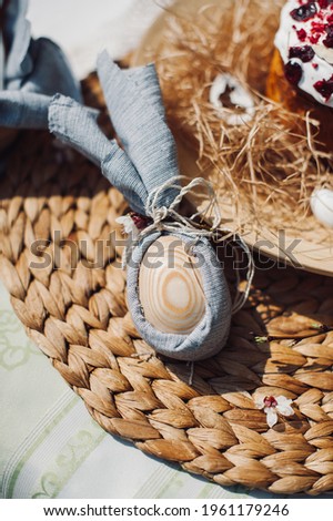 wooden egg decorated in grey napkin