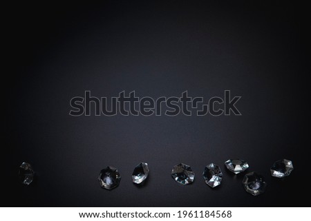 Elegant background, template for text or logo. Diamonds on the black background. Free space, copy space. Fashion, beauty backdrop.