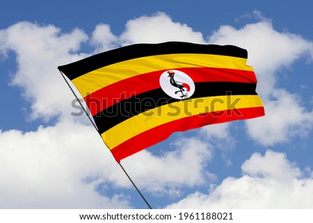Uganda flag isolated on sky background with clipping path. close up waving flag of Uganda. flag symbols of Uganda.