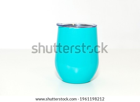 Turquoise thermocup with a lid on a white background