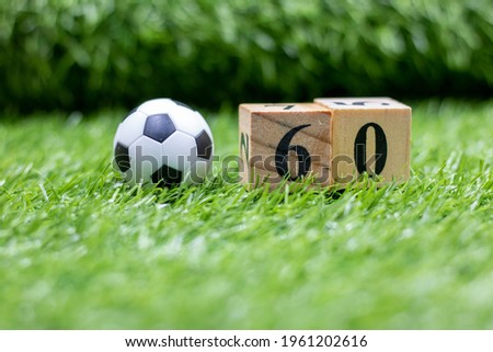 Soccer ball with number are on green grass