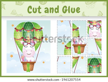 Children board game cut and glue with a cute unicorn on hot air balloon