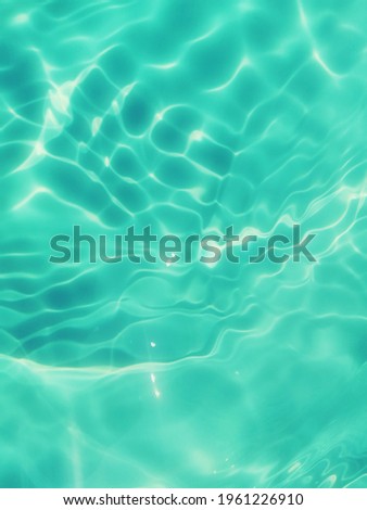 Reflection​ on​ surface​ blue​ water​ in​ the​ sea. Abstract​ of​ surface​ blue​ water​ for​ background. Closeup​ abstract​ of​ surface​ blue​ water. Splash​ed​ water​ in the​ swimming​pool.