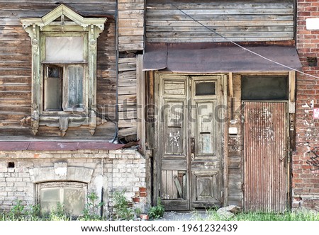 Nizhny Novgorod dilapidated wooden residential building (one window) Royalty-Free Stock Photo #1961232439