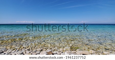Tranquil blue water and white washed rocks on the beach. Tobermory,Ontario,Canada 