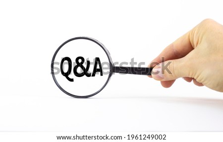 Q and A, questions and answers symbol. Magnifying glass with word 'Q and A, questions and answers' on beautiful white background. Business, Q and A, questions and answers concept, copy space.