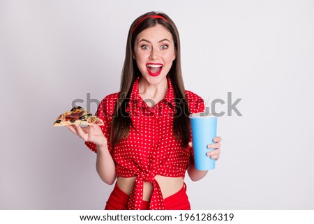 Photo of funky adorable girl hold pizza slice hold cup soda open mouth wear red dotted blouse isolated grey color background