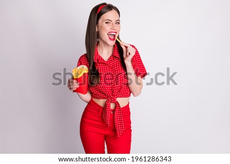 Photo of lovely girl hold paper box french fries open mouth wear red dotted blouse isolated grey color background