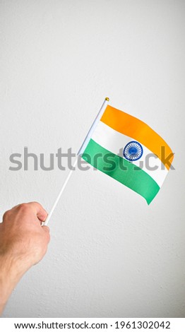 Hand holding hand flag of India