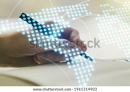 Abstract creative world map with connections and man hand writing in notebook on background, international trading concept. Multiexposure