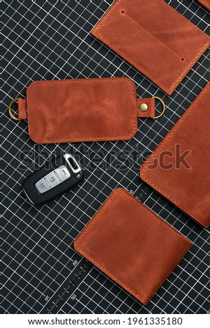 Handmade products made of genuine yellow and red leather. Leather passport cover, leather wallet. Leather goods for men. The view from the top