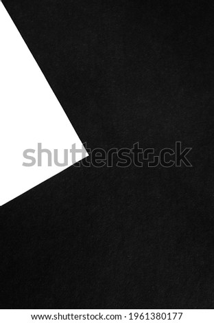 Geometric background of two paper sheets with black and white color. Texture backdrop. Concept of contrast and minimalism.