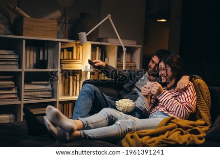 couple watching tv at home