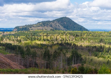 Vistas of mountains and hills surrounding a logging area in Washington State