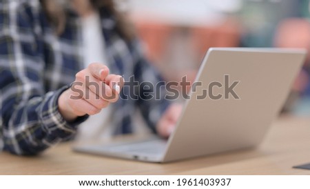 Female Hand Pointing at Camera while using Laptop, Close up