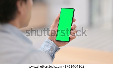 Rear View, Man Holding Smartphone with Green Chroma Key Screen