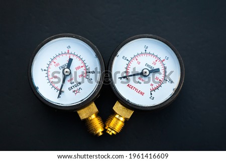 Two new manometers for acetylene and oxygen on a black background. Royalty-Free Stock Photo #1961416609
