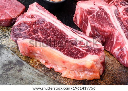 Raw beef steak, Club steak cut, on old dark rustic background