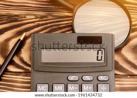 calculator on the table glasses money. High quality photo