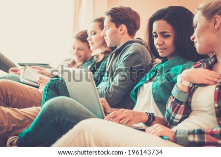 Group of young students preparing for exams in apartment interior
