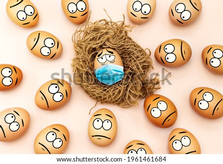 group of Easter sad eggs look at another egg with a medical mask infected with coronavirus 