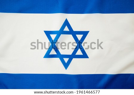 The bright waving flag of Israel. Background for design. National pride of Israel. Patriotism and commonwealth.