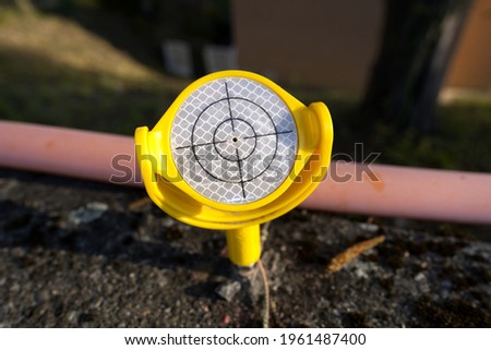 Yellow plastic measuring point with cross hair to register movements at construction site. Photo taken April 21st, 2021, Zurich, Switzerland.