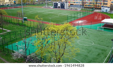 Open city sports grounds for playing football. Stadium, empty astro turf football field during lockdown in residential quarters, top view, sport concept in quarantine Royalty-Free Stock Photo #1961494828