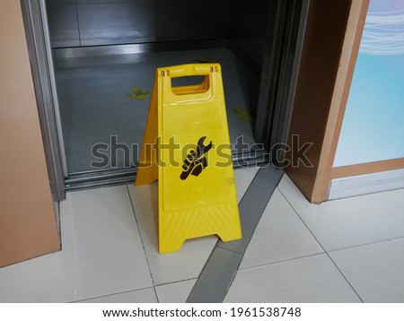 caution yellow warning elevator sign in repair.
