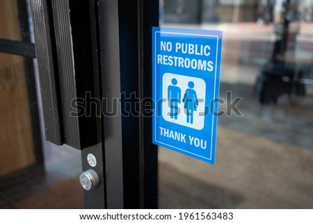No Public Restrooms storefront sign at a restaurant or a retail store in a city.