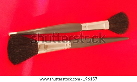 makeup brushes on red background
