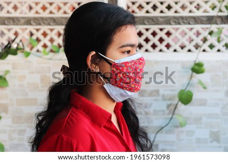double mask prevent infection, Young indian girl wearing two face mask to protect from new strain of coronavirus or new wave of covid-19 outbreak in india.
