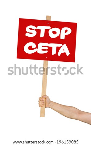 Person holding a sign saying Stop CETA