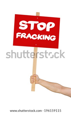 Person holding a sign saying Stop Fracking