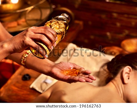 Young woman having oil massage spa treatment. Royalty-Free Stock Photo #196162763