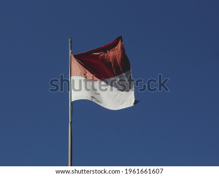 Indonesian flag flying in the blue sky. Independence of the nation and state