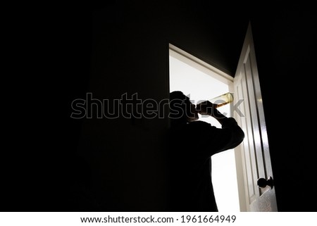 Men drank whiskey at the door until they were drunk. Royalty-Free Stock Photo #1961664949