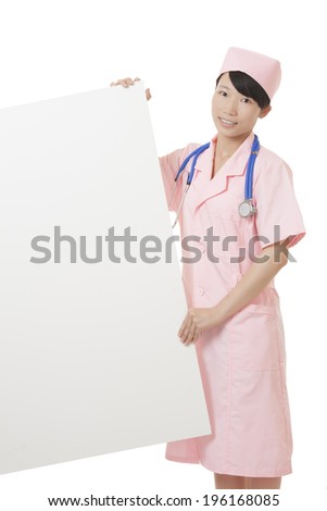 Beautiful Asian nurse holding a blank sign isolated on a white background