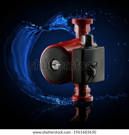 circulation water pump for heating and water supply systems. Isolated on a dark background Royalty-Free Stock Photo #1961683630