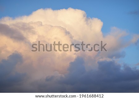 Clear blue sky with glowing pink and golden cumulus clouds after storm at sunset. Dramatic cloudscape. Concept art, meteorology, heaven, hope, peace, graphic resources, picturesque panoramic scenery