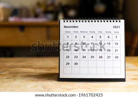 November 2021 calendar - month page showing date on wooden table Royalty-Free Stock Photo #1961702425