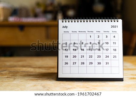 July 2021 calendar - month page showing date on wooden table