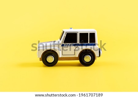Children's toy, car on a yellow background. Police car. Concept. Isolate. Copy space. High quality photo